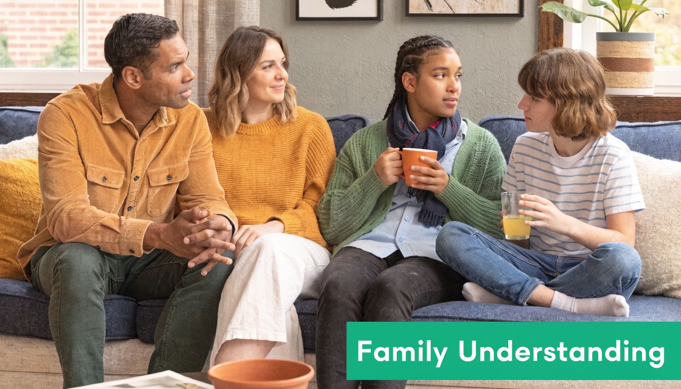 A diverse family sitting on a blue sofa engaged in a caring conversation during therapy session.