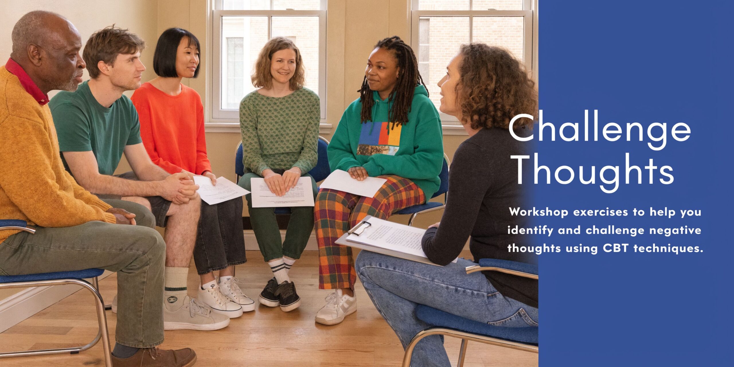A diverse group of people sitting in a circle during a guided group mental health workshop.