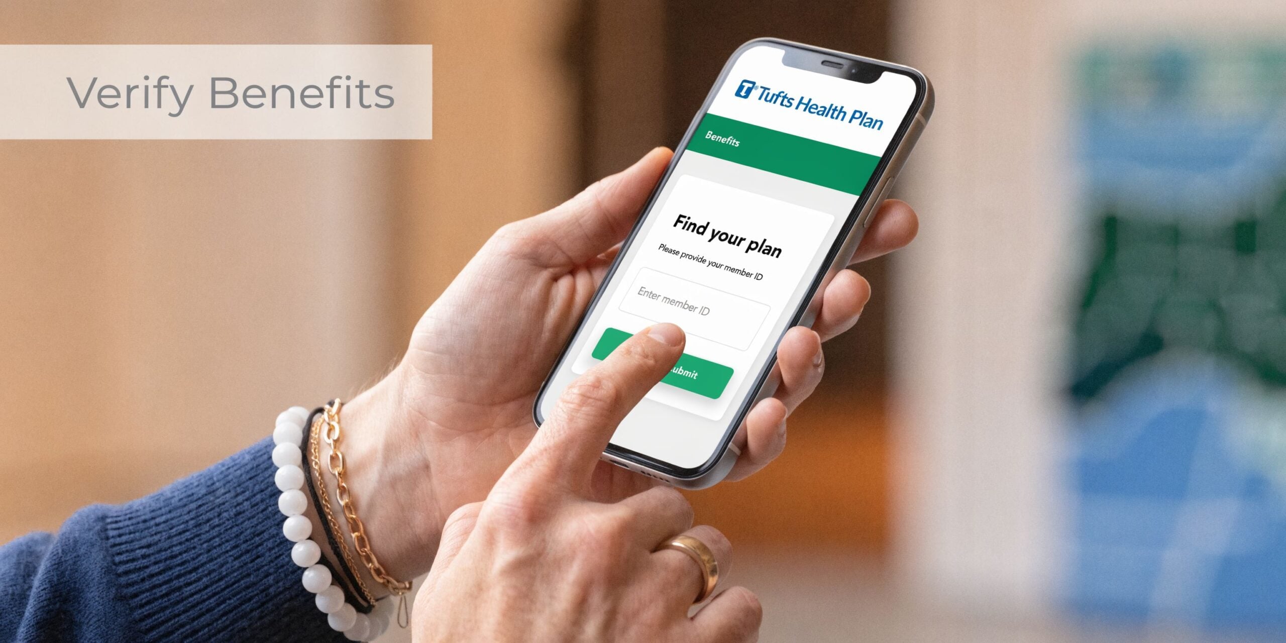 A person using a Tufts Health Plan mobile app on their smartphone to verify insurance benefits.
